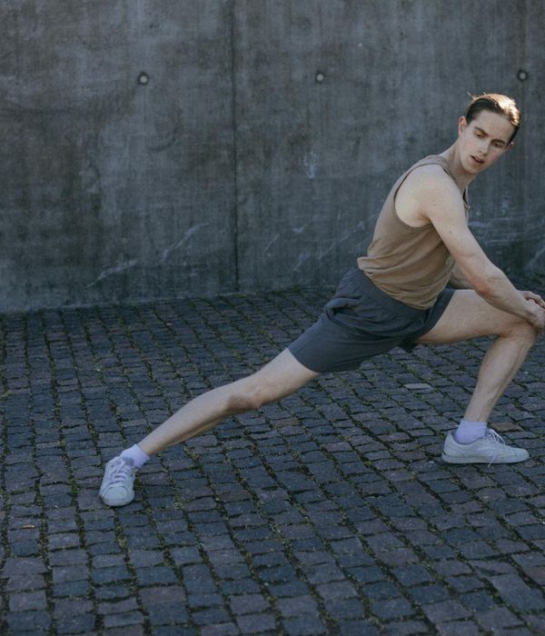 Person feeling energized and stretching outdoors in a natural setting.